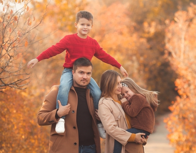 Happy,Family,Walking,In,The,Fall,Park.,Portrait,Of,A